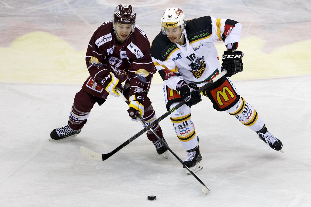 Geneve-Servette's Alexandre Picard, of Canada, left, vies for the puck with Lugano's Lorenz Kienzle, right, during the second leg of the Playoffs quarterfinals game of National League A (NLA) Swiss Championship between Geneve-Servette HC and HC Lugano, at the ice stadium Les Vernets, in Geneva, Switzerland, Tuesday, March 3, 2015. (KEYSTONE/Salvatore Di Nolfi)
