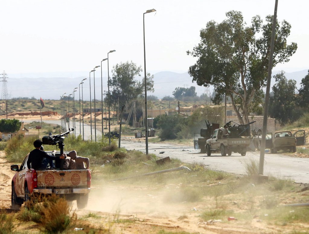 epa04670051 A Libyan militia advances during clashes with rivals near Bir al-Ghanam, 90 km north of Tripoli, Libya, 19 march 2015. According to local reports one member of a militia blew himself up in clashes which claimed the lives of nine and left 14 wounded from both sides, as fighting continues in the war torn country, in which a senior commander from a group which has pledged allegiance to the group calling themselves the Islamic State (IS), Tunisian Ahmed Rouissi, was killed 17 March, and as the situation in Libya is expected to be discussed at an EU Heads of government meeting taking place in Brussels.  EPA/STR