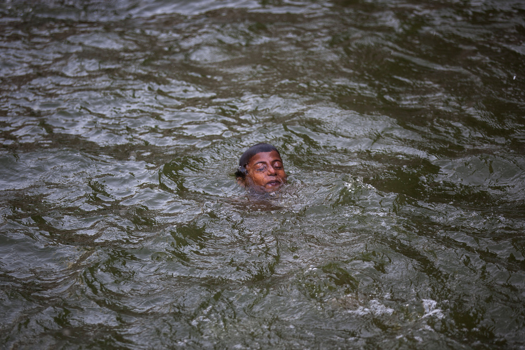 An Indian boy swims in a water body on a hot summer day in New Delhi, India, Tuesday, May 26, 2015. Delhi recorded a maximum temperature of 46 degrees Celsius on Tuesday. In southern India, more than 750 people have died since the middle of April as soaring summer temperatures scorch the country, officials said Tuesday. (AP Photo/Tsering Topgyal)