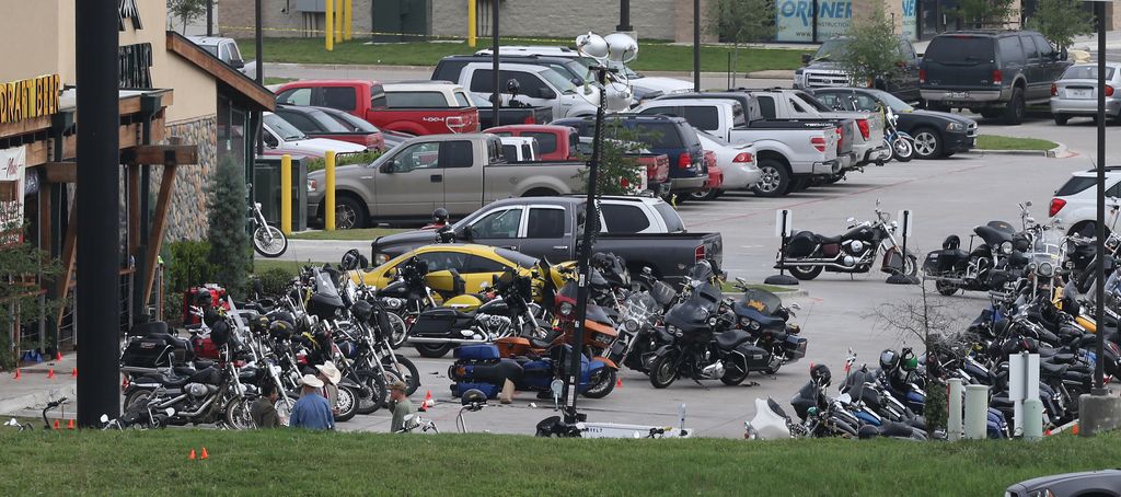 Law enforcement continue to investigate the motorcycle gang related shooting at the Twin Peaks restaurant, Monday, May 18, 2015, in Waco, Texas, where 9 were killed Sunday and over a dozen injured. Waco police on Monday announced the Texas Alcoholic Beverage Commission closed Twin Peaks for a week amid safety concerns. .(AP Photo, Jerry Larson)