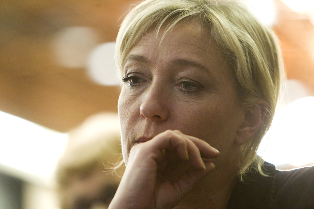 French far-right leader and National Front Party candidate for the 2012 French presidential elections, Marine Le Pen is seen during a meeting in Paris on Tuesday, Feb. 21, 2012. (AP Photo/Jacques Brinon)