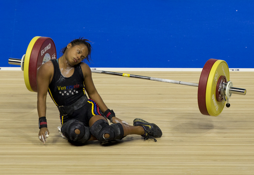 Venezuela's Genesis Rodriguez Gomez collapses during a lift attempt in the women's 53kg weightlifting at the Pan Am Games in Oshawa, Ontario, Sunday, July 12, 2015. Rodriguez took silver in the event.(AP Photo/Rebecca Blackwell)
