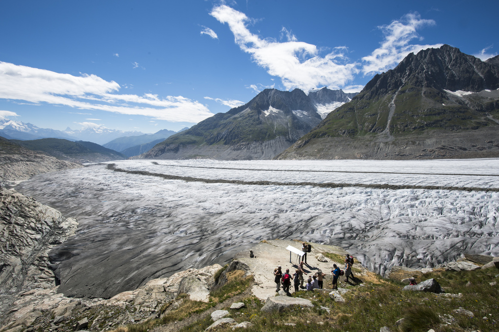 Tourists above the Aletsch glacier on a viewpoint, in Fiesch, Switzerland, Tuesday, July 28, 2015. With 23 kilometers is the Aletsch glacier the longest glacier of Europe and belongs to the UNESCO world heritage sites. (KEYSTONE/Dominic Steinmann)