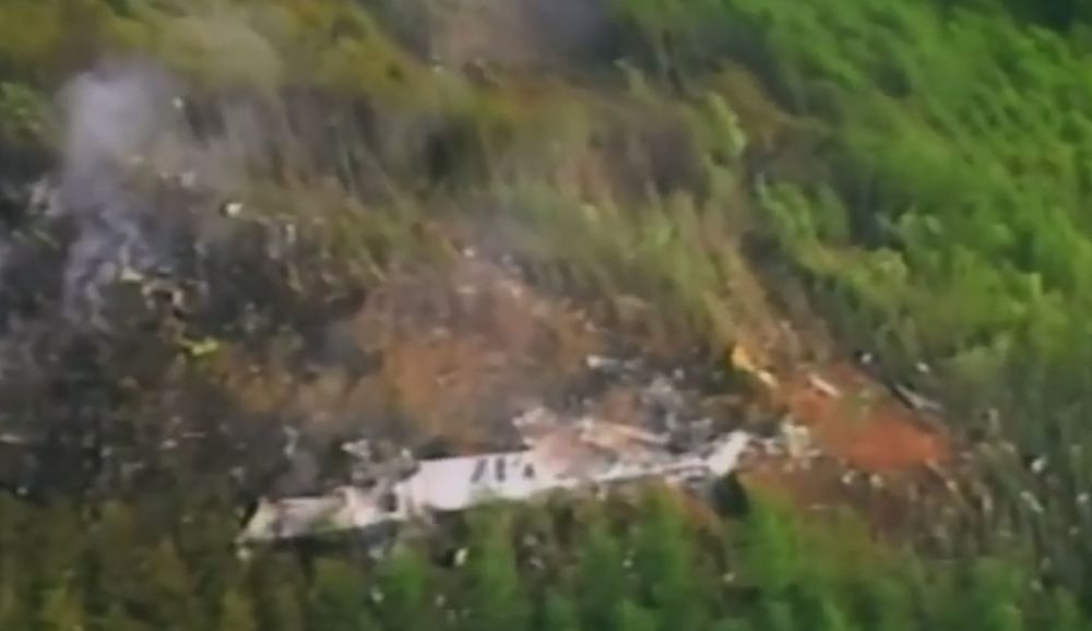 In this photo dated Wednesday, July 29, 2015, French police officers carry a piece of debris from a plane in Saint-Andre, Reunion Island. Air safety investigators, one of them a Boeing investigator, have identified the component as a "flaperon" from the trailing edge of a Boeing 777 wing, a U.S. official said. Flight 370, which disappeared March 8, 2014, with 239 people on board, is the only 777 known to be missing. (AP Photo/Lucas Marie)