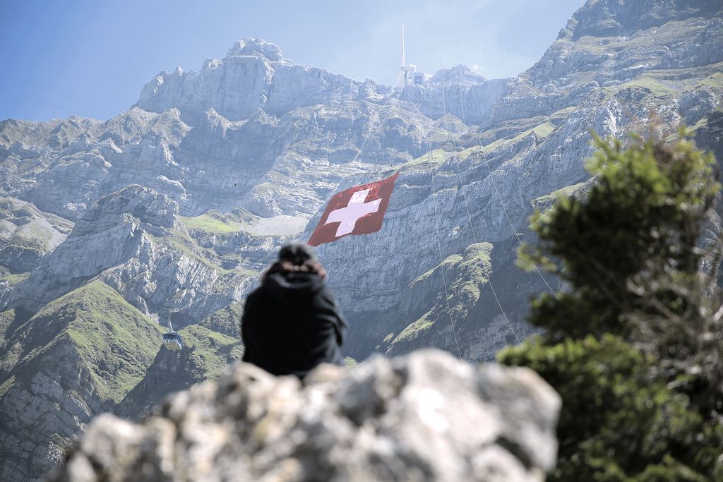 The world's largest Swiss flag is pictured at the ruggedly rock face of the mountain Saentis in Schwaegalp, eastern Switzerland, Friday, July 31, 2015. The flag measures 80 meters to 80 meters and is the world's largest Swiss flag. Saturday 1 August Switzerland is celebrating the national holiday. (KEYSTONE/Pascal Bloch)