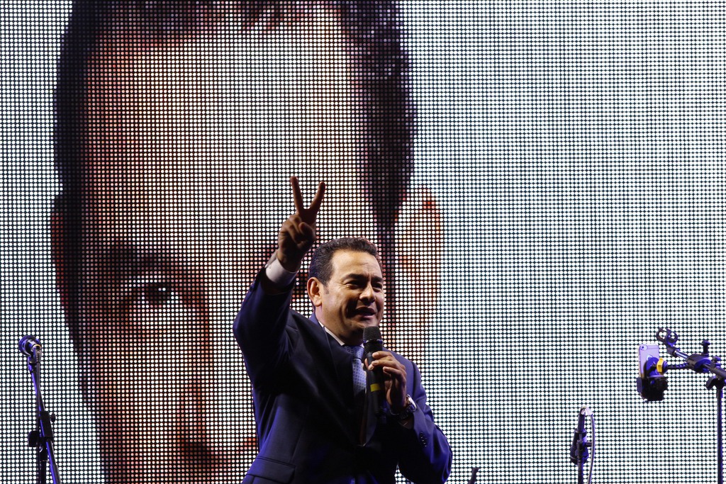 Jimmy Morales , flashes a victory sign to his supporters at his party headquarters in Guatemala City, Sunday, Sept. 6, 2015. Guatemalans headed to the polls Sunday to elect a president, vice president, members of Congress and the Central American Parliament, and local authorities for municipalities nationwide. (AP Photo/Luis Soto)