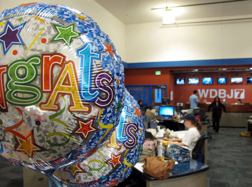 Balloons hang from the desk of WDBJ's Melissa Ott, who was engaged to cameraman Adam Ward at the station in Roanoke, Va., Wednesday, Aug. 26, 2015. Ward and reporter Alison Parker were fatally shot on-air by Vester Lee Flanagan, a former staffer who used the on-air name of Bryce Williams and was fired by WDBJ. (AP Photo/Allen G. Breed)