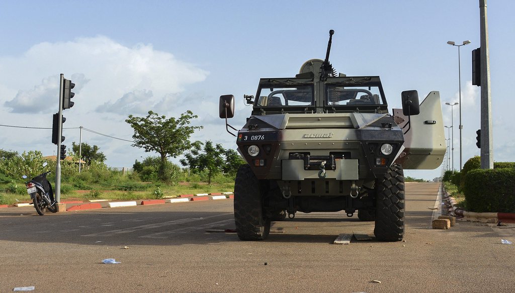 epa04935677 An abandoned armoured military vehicle is seen on the streets during protests against a coup in Ouagadougou, Burkina Faso, 17 September 2015. Media reports indicate protests have sparked in Ouagadougou after Presidential guard officers seized power in a coup. The presidential guard detained President Michel Kafando and Prime Minister Isaac Zida at a cabinet meeting at the presidential palace. Ten deaths have been reported in the violence as a reaction to the coup. A statement issued by the coup leaders said the country would be led by General Gilbert Diendere who was former president Blaise Compaore's chief-of-staff.  EPA/AHMED YEMPABOU