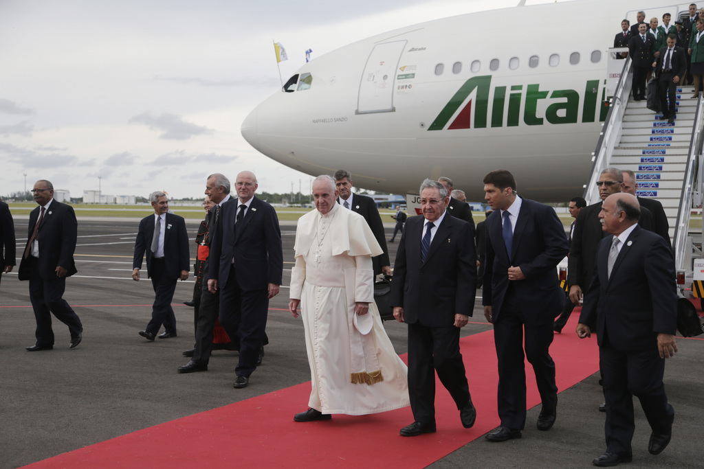 Cuba's President Raul Castro escorts Pope Francis during the pope's arrival ceremony at the airport in Havana, Cuba, Saturday, Sept. 19, 2015. Pope Francis begins a 10-day trip to Cuba and the United States on Saturday, embarking on his first trip to the onetime Cold War foes after helping to nudge forward their historic rapprochement. (AP Photo/Ramon Espinosa)