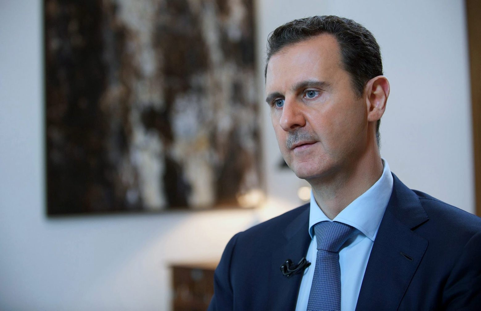 In this photo released by the Syrian official news agency SANA, shows Syrian President Bashar Assad, speaking during an interview with the Iran's Khabar TV, in Damascus, Syria, Sunday, Oct. 4, 2015. Assad said in the interview aired Sunday the air campaign by Russia against "terrorists" in his country must succeed or the whole region will be destroyed. He also accused Western nations of fueling the refugee crisis. (SANA via AP) Mideast Syria