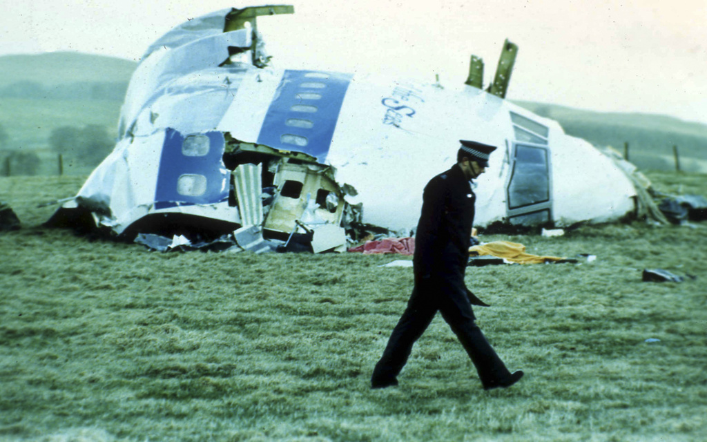 In this December 1988 photo, a police officer walks past the wreckage in Lockerbie, Scotland of Pan Am Flight 103 from London to New York. In late 2003, after years of denial, Gadhafi's Libya acknowledged responsibility for the bombing of the jumbo jet that killed 270 people. As rebels swarmed into Tripoli, Libya, late Sunday, Aug. 21, 2011, and Gadhafi's son and one-time heir apparent Seif al-Islam was arrested, Gadhafi's rule was all but over, even though some loyalists continued to resist. (AP Photo)