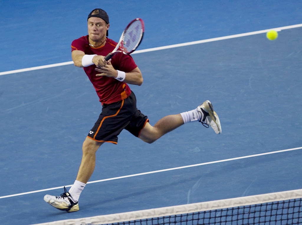 epa03063368 Lleyton Hewitt of Australia returns the ball during his men's singles first round match against Cedrik-Marcel Stebe of Germany on the second day of the Australian Open Grand Slam tennis tournament in Melbourne, Australia, 17 January 2012.  EPA/AHMAD YUSNI