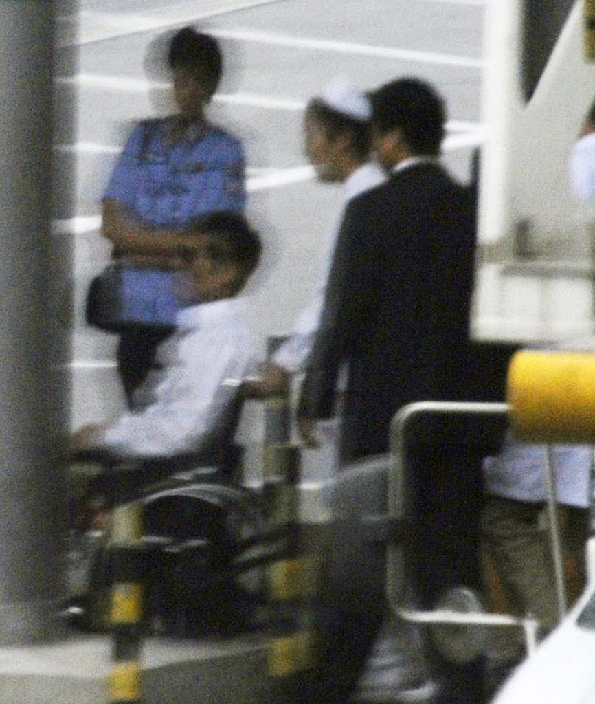Chinese activist Chen Guangcheng, in a wheelchair, is helped to head to a commercial flight Saturday, May 19, 2012 at Beijing International Airport in Beijing. Chen was hurriedly taken from a hospital Saturday and boarded a plane that took off for the United States, closing a nearly monthlong diplomatic tussle that had tested U.S.-China relations. (AP Photo/Kyodo News) JAPAN OUT, MANDATORY CREDIT, NO LICENSING IN CHINA, HONG KONG, JAPAN, SOUTH KOREA AND FRANCE === BEST QUALITY, JAPAN OUT, MANDATORY CREDIT, NO LICENSING IN CHINA, HONG KONG, JAPAN, SOUTH KOREA AND FRANCE === 