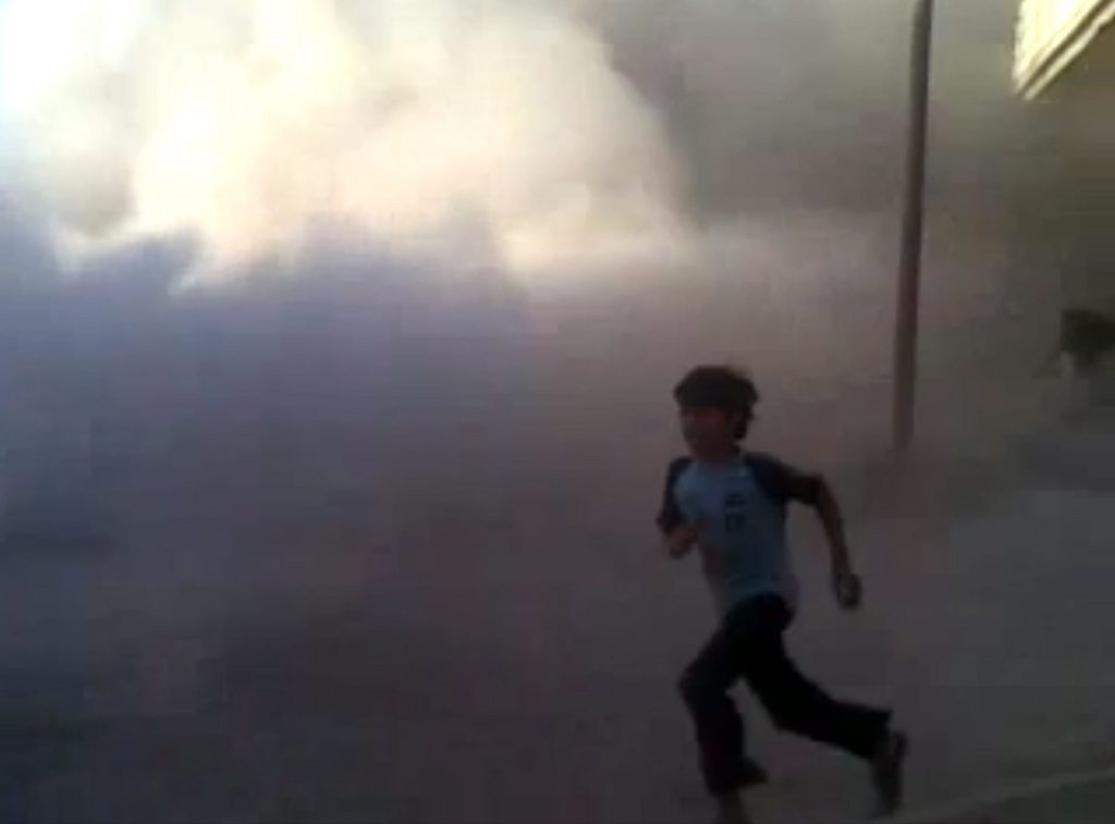 This frame grab made from an amateur video provided by Syrian activists on Monday, May 28, 2012, purports to show the massacre in Houla on May 25 that killed more than 100 people, many of them children. The amateur footage shows people running along a street, purportedly just after the attack on Houla started. (AP Photo/Amateur Video via AP video) THE ASSOCIATED PRESS IS UNABLE TO INDEPENDENTLY VERIFY THE AUTHENTICITY, CONTENT, LOCATION OR DATE OF THIS CITIZEN JOURNALISM IMAGE