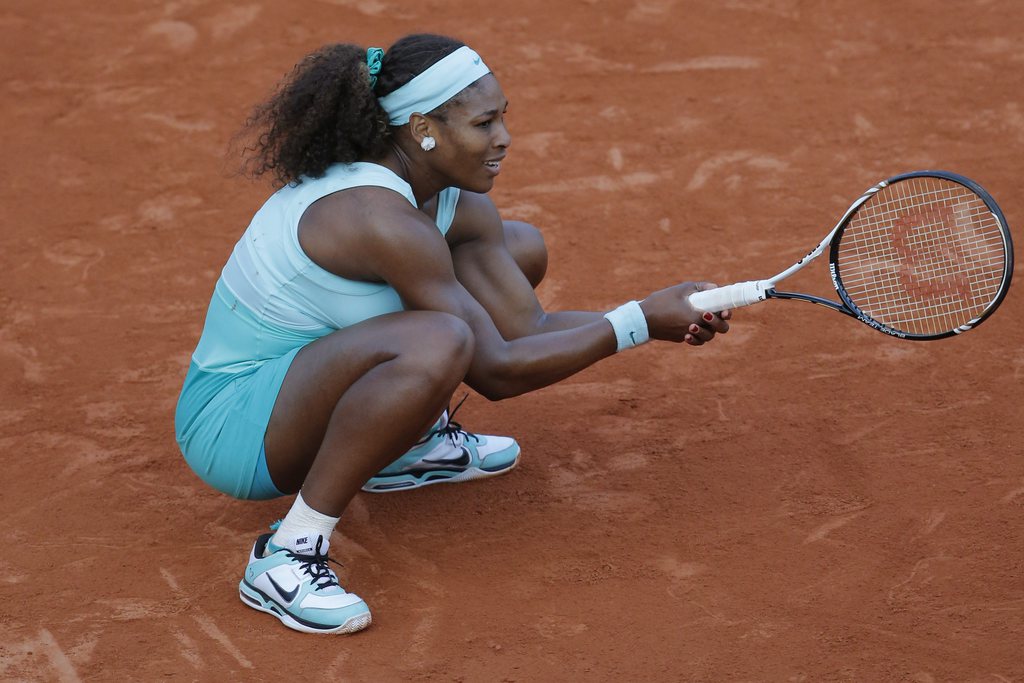 Serena Williams of the US squats on the clay in her first round match against Virginie Razzano of France at the French Open tennis tournament in Roland Garros stadium in Paris, Tuesday May 29, 2012. Razzano won in three sets, 6-4, 6-7. 3-6. (AP Photo/Christophe Ena)
