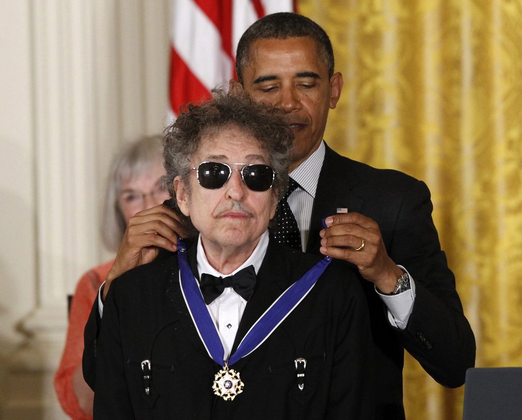President Barack Obama presents rock legend Bob Dylan with a Medal of Freedom, Tuesday, May 29, 2012, during a ceremony at the White House in Washington. (AP Photo/Charles Dharapak)