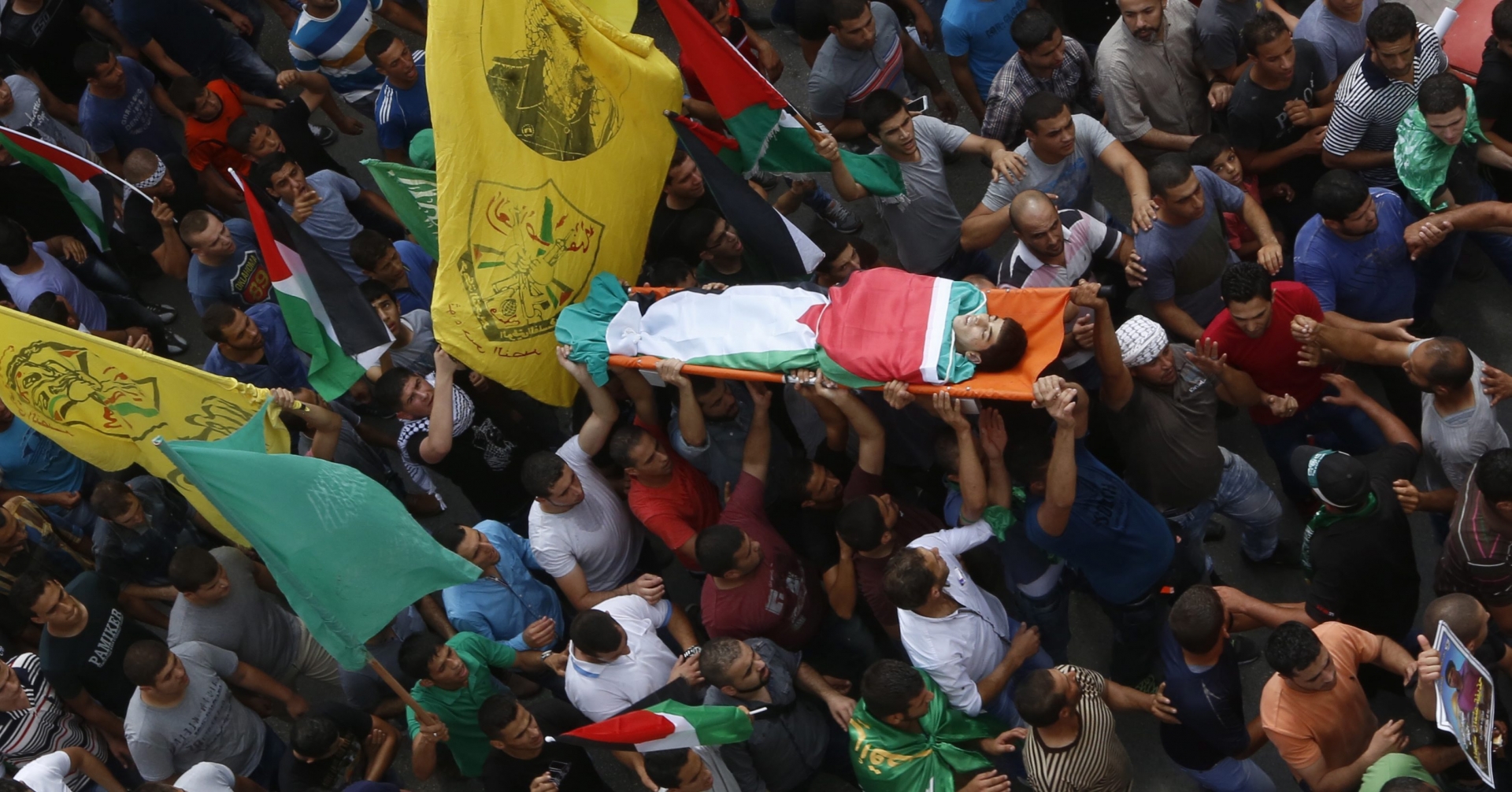 epa04964318 Palestinians carry body of 18-year-old Palestinian youth Huthayfa Othman during his funeral in the West Bank village of Bala, near Tulkarem, 05 October 2015. Israeli forces shot dead the Palestinian teenager during clashes in the northern West Bank village of Bala overnight 04 October, medics said. Reportedly threeother young men were also shot during the clashes.  EPA/ALAA BADARNEH
