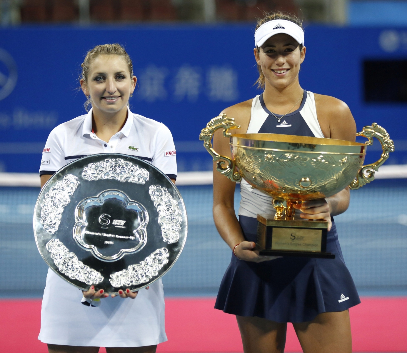 epa04973146 Winner Garbine Muguruza (R) of Spain and runner up Timea Bacsinszky of Switzerland pose with their trophies during the awarding ceremony of the women's singles final match for the China Open tennis tournament at the National Tennis Center in Beijing, China, 11 October 2015.  EPA/WU HONG