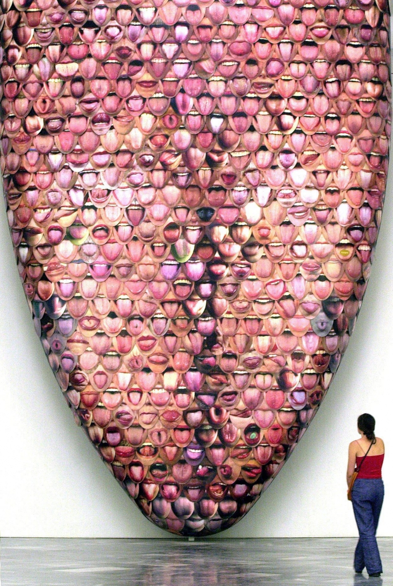 A young visitor watches a work by Spanish artist Antoni Miralda composed of hundreds of tongues on Thursday 19 July 2001 at the Arts Biennial of Valencia at El Carmen Convent. EPA PHOTO (KEYSTONE/EFE/ALBERTO ESTEVEZ)