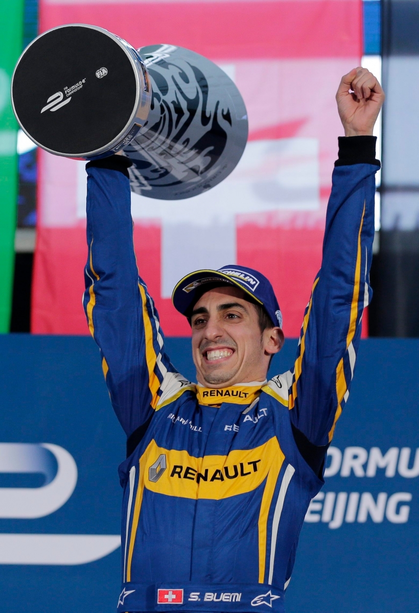 E.dams Renault driver Sebastien Buemi of Switzerland celebrates with his trophy after winning the Formula E Beijing ePrix auto race at the Olympic Park in Beijing, Saturday, Oct. 24, 2015. (AP Photo/Andy Wong) China ePrix Auto Racing