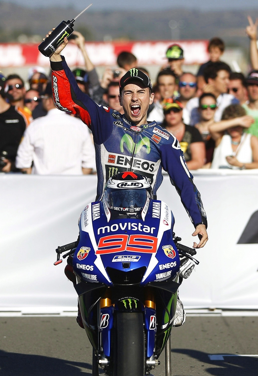 epa05016855 Spanish MotoGP rider Jorge Lorenzo of the Movistar Yamaha team celebrates after winning the Motorcycling Grand Prix of Valencia at the Ricardo Tomo circuit in Valencia, Spain, 08 November 2015. Lorenzo took the 2015 World Championship title.  EPA/KAI FOERSTERLING