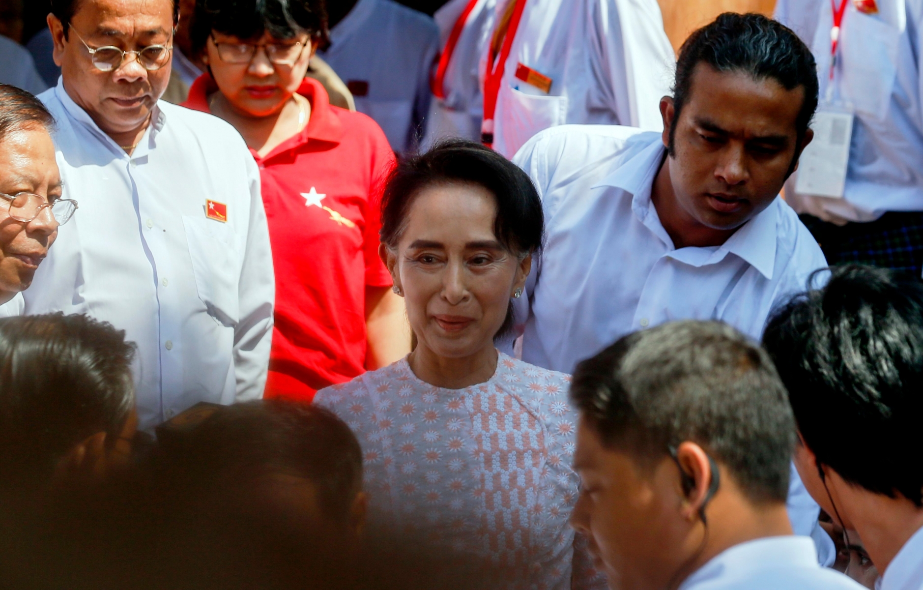 epa05017620 Myanmar opposition leader Aung San Suu Kyi (C), chairperson of National League for Democracy (NLD) party, leaves NLD headquarters to deliver a speech, Yangon, Myanmar, 09 November 2015. Myanmar opposition leader Aung San Suu Kyi hints at victory in her first address since the polls closed a day earlier. 'It is too early to congratulate our candidates that will be victors,' she said at the headquarters of her National League for Democracy party, 'but I think you all have an idea of the results.' She asked her supporters to not be boastful if they win or make the losers 'feel bad.'  EPA/LYNN BO BO MYANMAR ELECTIONS