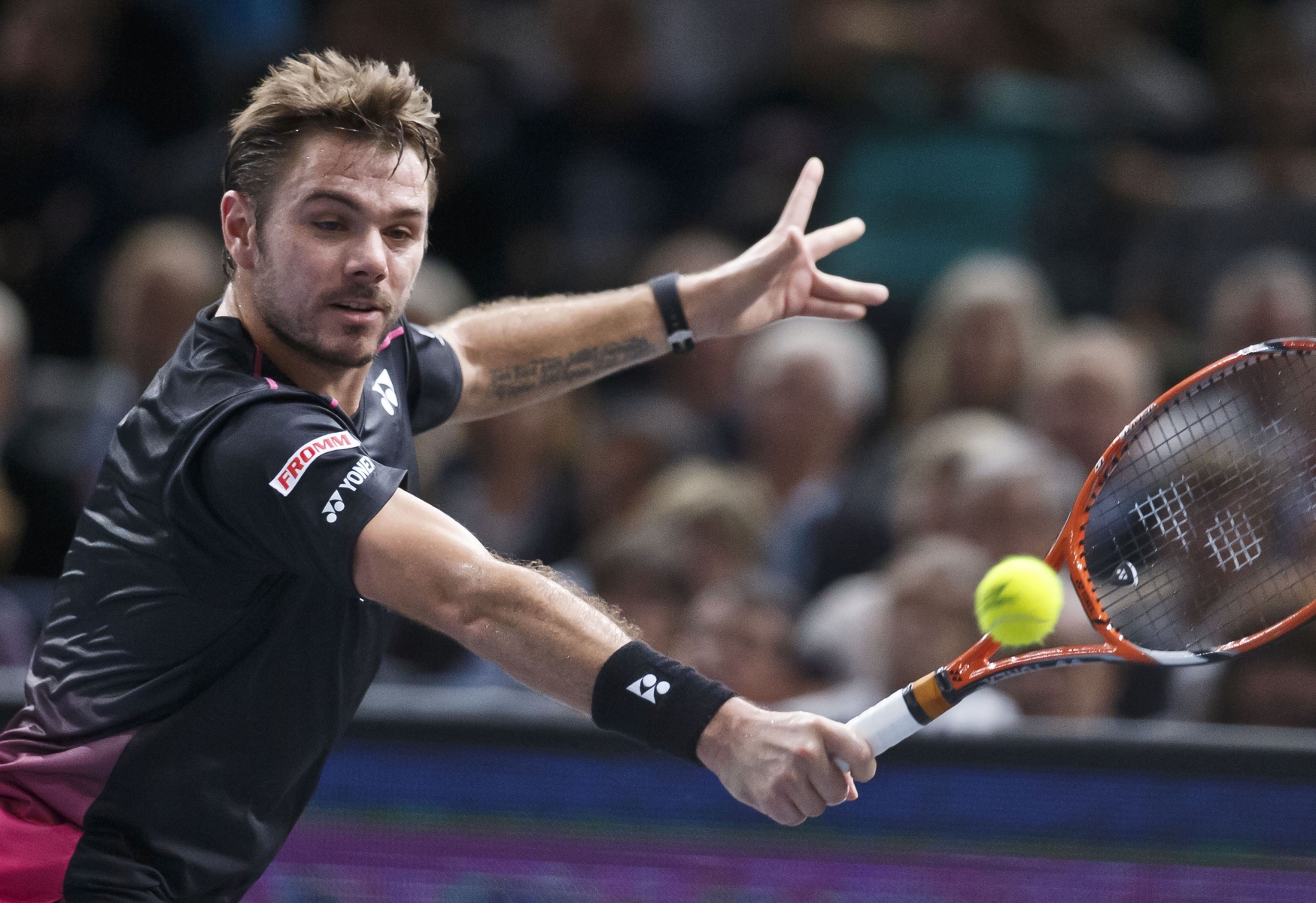 Stanilas Wawrinka of Switzerland returns the ball to Novak Djokovic of Serbia during their semifinal match of the BNP Masters tennis tournament at the Paris Bercy Arena, in Paris, France, Saturday, Nov. 7, 2015. (AP Photo/Michel Euler)