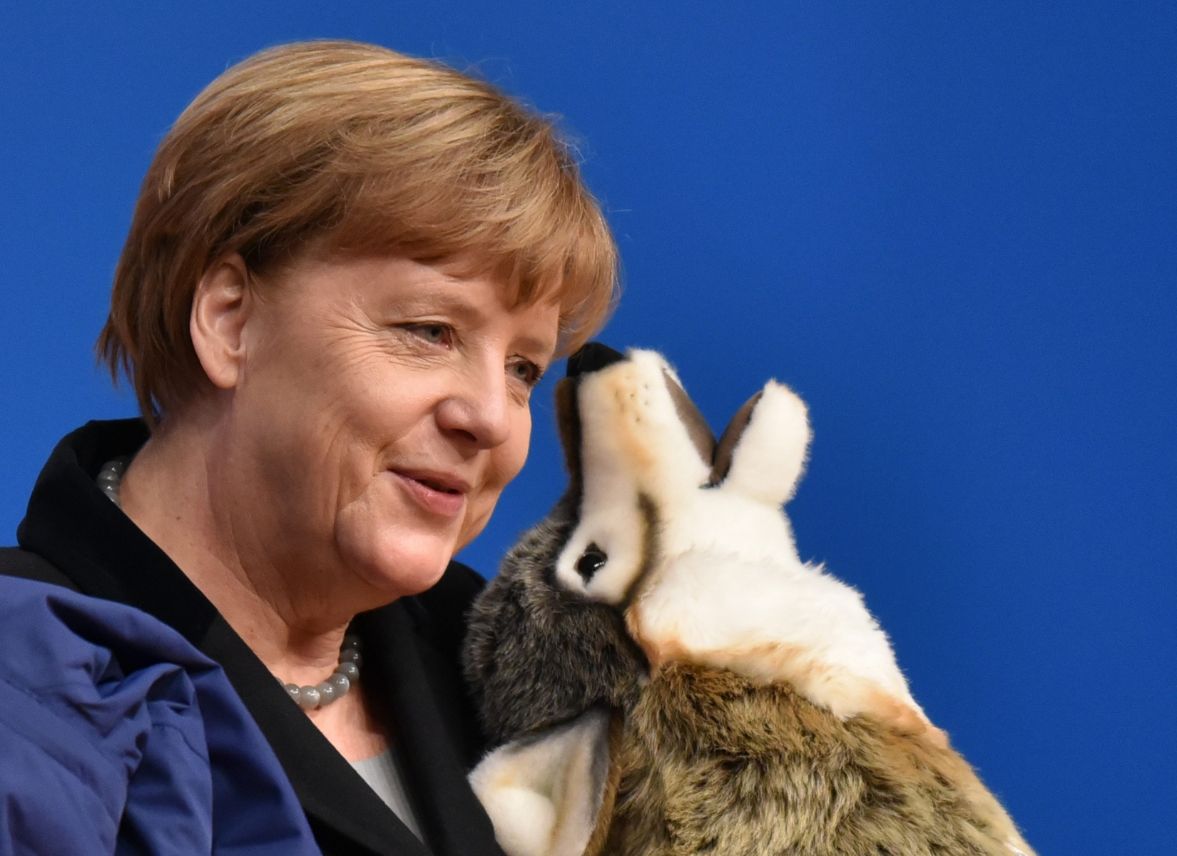 epa05068670 CDU federal chairwoman and Chancellor Angela Merkel holds a stuffed wolf at the CDU (Christian Democratic Party) federal party congress in Karlsruhe, Germany, 14 December 2015. The CDU is discussing, among other things, asylum policy. With an eye to the coming state parliamentary elections in March, CDU top-candidtate Guido Wolf declared Baden-Wuerttemberg 'Wolf's state of expectation' and gave Angela Merkel the stuffed wolf.  EPA/UWE ANSPACH GERMANY PARTIES CDU PARTY CONVENTION