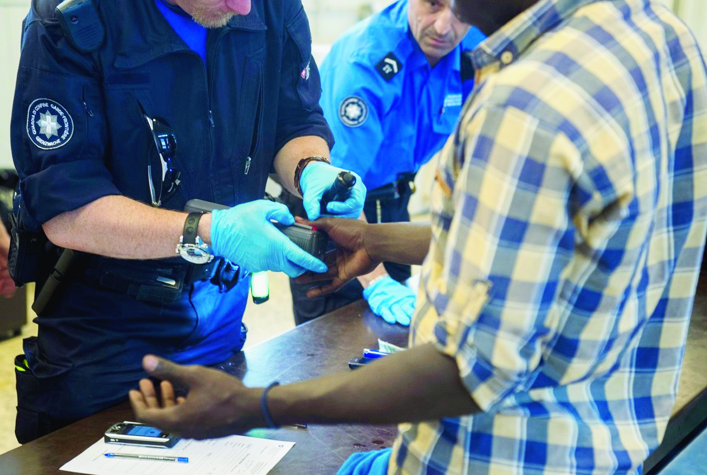 ZUR ASYLSTATISTIK 2015 STELLEN WIR IHNEN AM DONNERSTAG, 28. JANUAR 2016, FOLGENDES ARCHIVBILD ZUR VERFUEGUNG -  Ein Asylbewerber gibt seinen Fingerabdruck beim Personal des Grenzwachcorps ab, bei der Grenzkontrolle am Zoll des Bahnhofs Chiasso aufgenommen am Dienstag, 16. Juni 2015.  (KEYSTONE/TI-PRESS/Benedetto Galli) SCHWEIZ ASYLSTATISTIK 2015