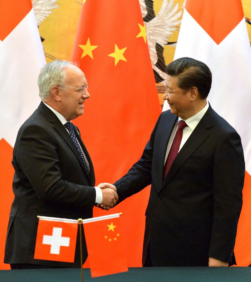 Switzerland's Federal President Johann Schneider-Ammann, left, and Chinese President Xi Jinping shake hands at the end of the signing ceremony at the Great Hall of the People in Beijing Friday, April 8, 2016. (Kenzaburo Fukuhara/Pool Photo via AP) China Switzerland