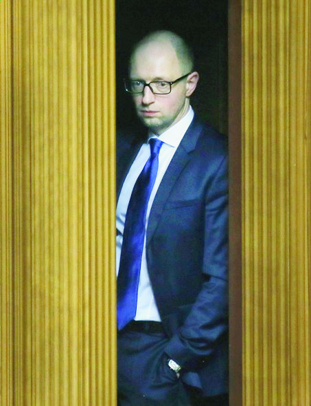 FILE -  In this Tuesday, Dec. 2, 2014 Ukrainian Prime Minister Arseniy Yatsenyuk looks at the parliament session hall during a parliament  session in Kiev, Ukraine.   In a televised address on Sunday, April 10, 2016, Ukraineís embattled Prime Minister Arseniy Yatsenyuk announced his resignation, with his official resignation taking effect Tuesday, opening the way for the formation of a new government to end a drawn-out political crisis.  (AP Photo/Efrem Lukatsky)  Ukraine Prime Minister