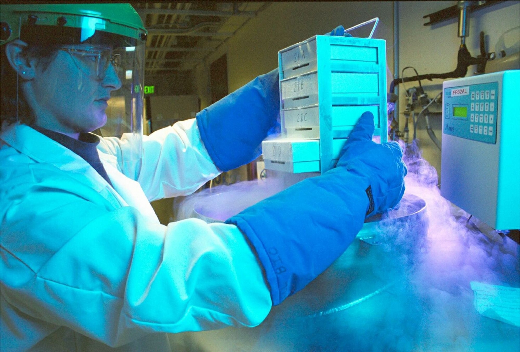 This undated picture provided by Schering AG shows an employee withdrawing deep-frozen cells for in-vitro culturing. German pharmaceutical company Schering AG Wednesday, Feb 9, 2005,  reported a 23 percent rise in fourth quarter net profit thanks to rising sales of high-margin contraceptives, a lower tax rate and cost savings. (KEYSTONE/AP Photo/Schering) === EDITORIAL USE ONLY     MANDATORY CREDIT === DEUTSCHLAND PHARMA SCHERING