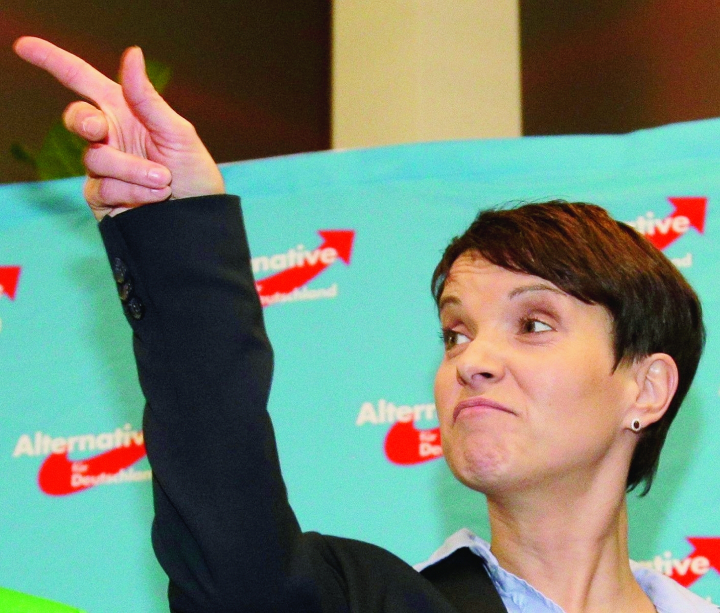 Frauke Petry, chairwoman of the AfD, points her finger at the gathering of the right-populist AfD (Alternative for Germany) after the closing of the state elections in the German federal states of Baden-Wuerttemberg, Rhineland-Palatinate and Saxony-Anhalt in Berlin, Germany, Sunday, March 13, 2016. Three German states were voting Sunday in the first significant political test since the country saw a massive influx of migrants. (AP Photo/Michael Sohn) APTOPX Germany Elections
