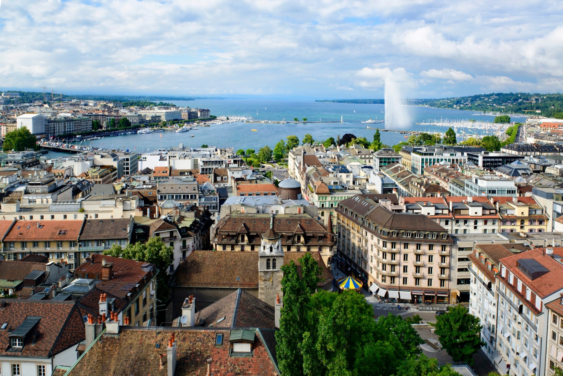 Geneva cityscape with roofs, houses, lake and fountain Geneva