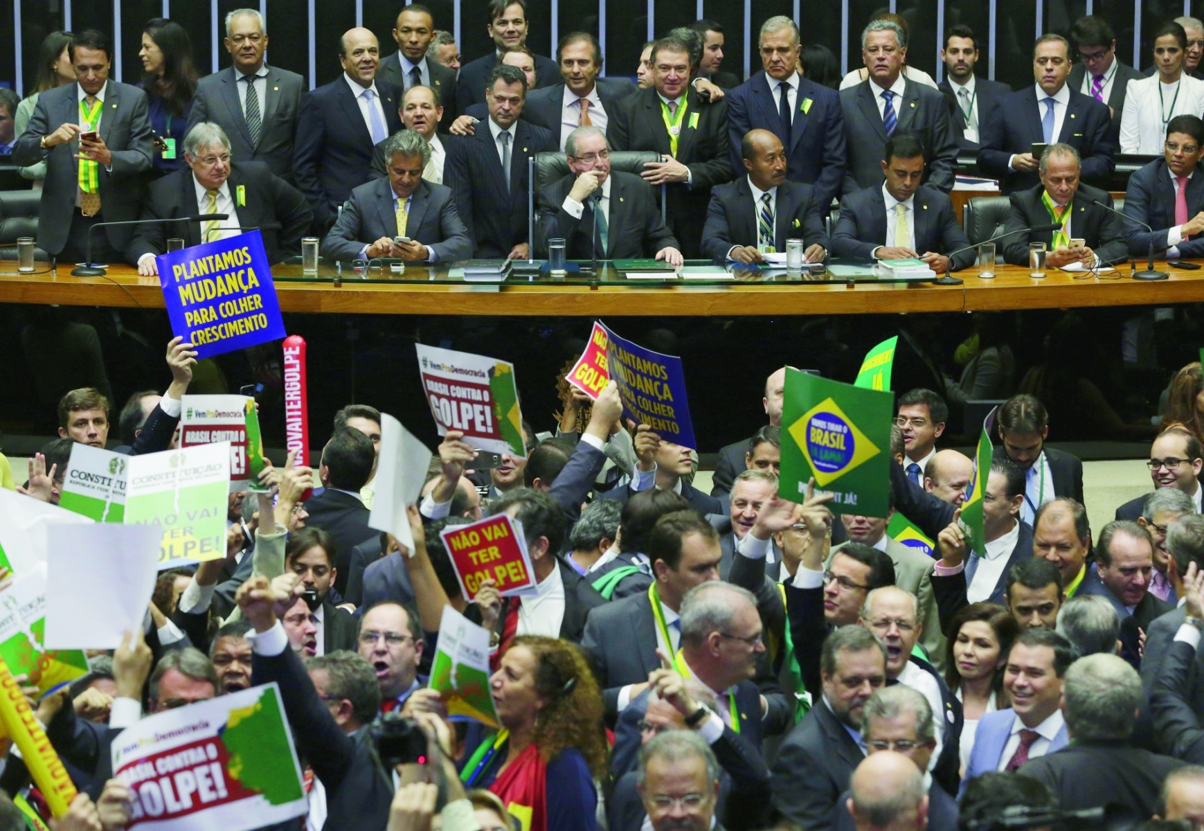 President of the Chamber of Deputies Eduardo Cunha, center on the table, starts the session on whether or not to impeachment President Dilma Rousseff, in Brasilia, Brazil, Sunday, April 17, 2016. The vote will determine whether the impeachment proceeds to the Senate. Rousseff is accused of violating Brazil's fiscal laws to shore up public support amid a flagging economy. (AP Photo/Eraldo Peres) Brazil Political Crisis