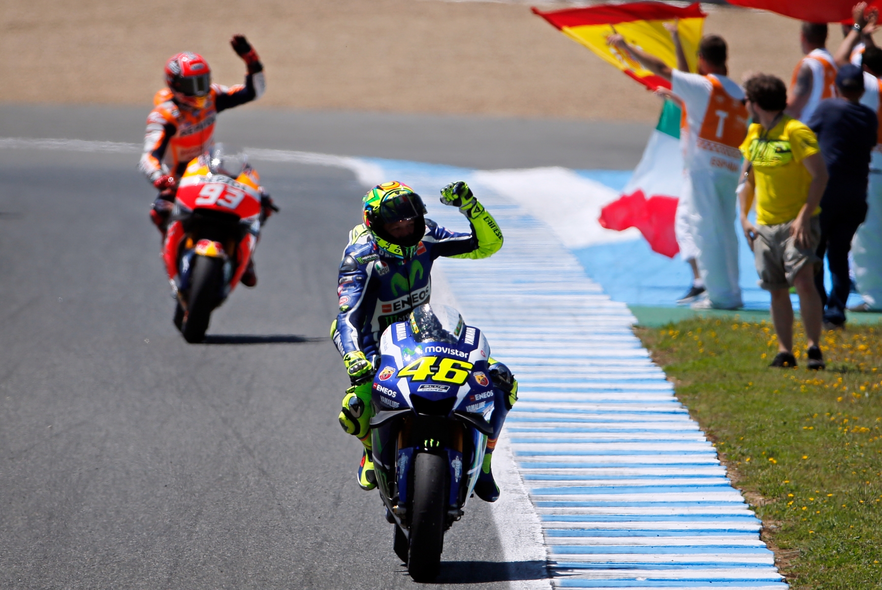 Moto GP rider Valentino Rossi of Italy celebrates after winning the MotoGP race of Spain's Motorcycle Grand Prix at the Jerez race track in Jerez de la Frontera, southern Spain, Sunday, April 24, 2016. At left is championship leader Marc Marquez of Spain who finished third. (AP Photo/Miguel Angel Morenatti)