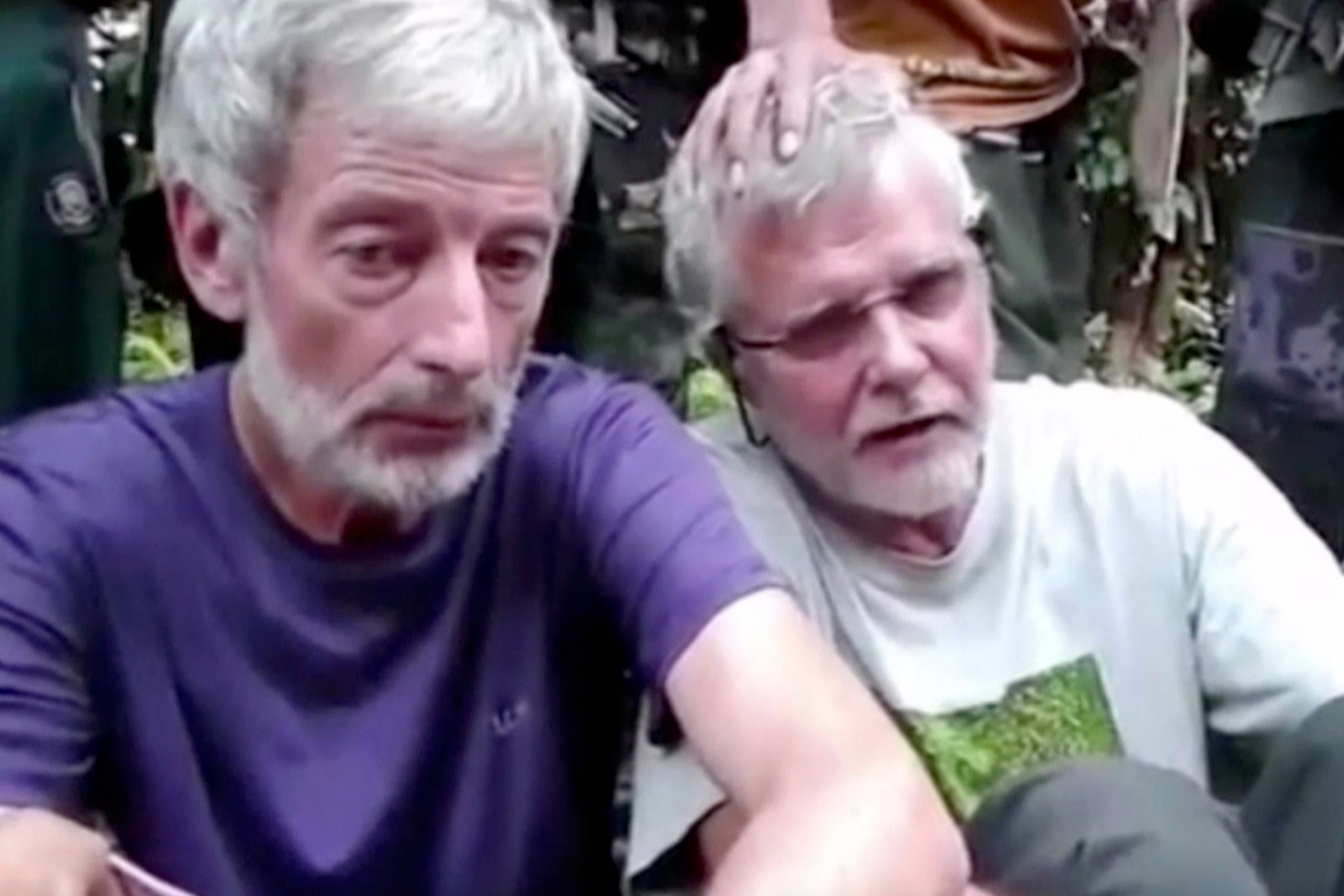 This image made from undated militant video, shows Canadians John Ridsdel, right, and Robert Hall. Canada's Prime Minister Justin Trudeau confirmed that the decapitated head of a Caucasian male recovered Monday, April 25, 2016, in the southern Philippines belongs to Ridsdel, who was taken hostage by Abu Sayyaf militants in September 2015. (Militant Video via AP Video) NO SALES, MANDATORY CREDIT Philippines Kidnapped Foreigners