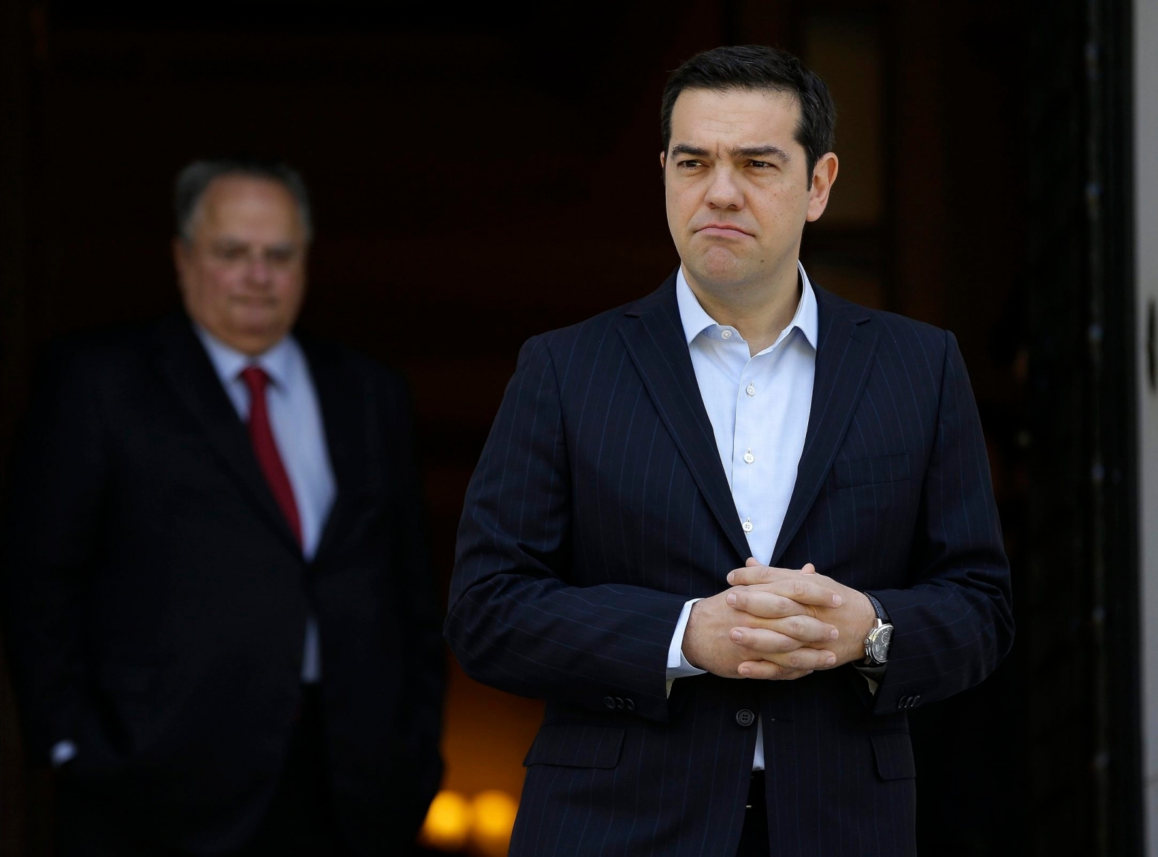 Greece's Prime Minister Alexis Tsirpas, right, waits for the arrival of the Cypriot President Nicos Anastasiades at the Maximos Mansion in Athens, Wednesday, May 25, 2016. Greece has won an essential batch of bailout funds from international creditors following agreement among the 19 eurozone finance ministers and can start looking forward to debt relief in the future. (AP Photo/Thanassis Stavrakis) Greece Bailout