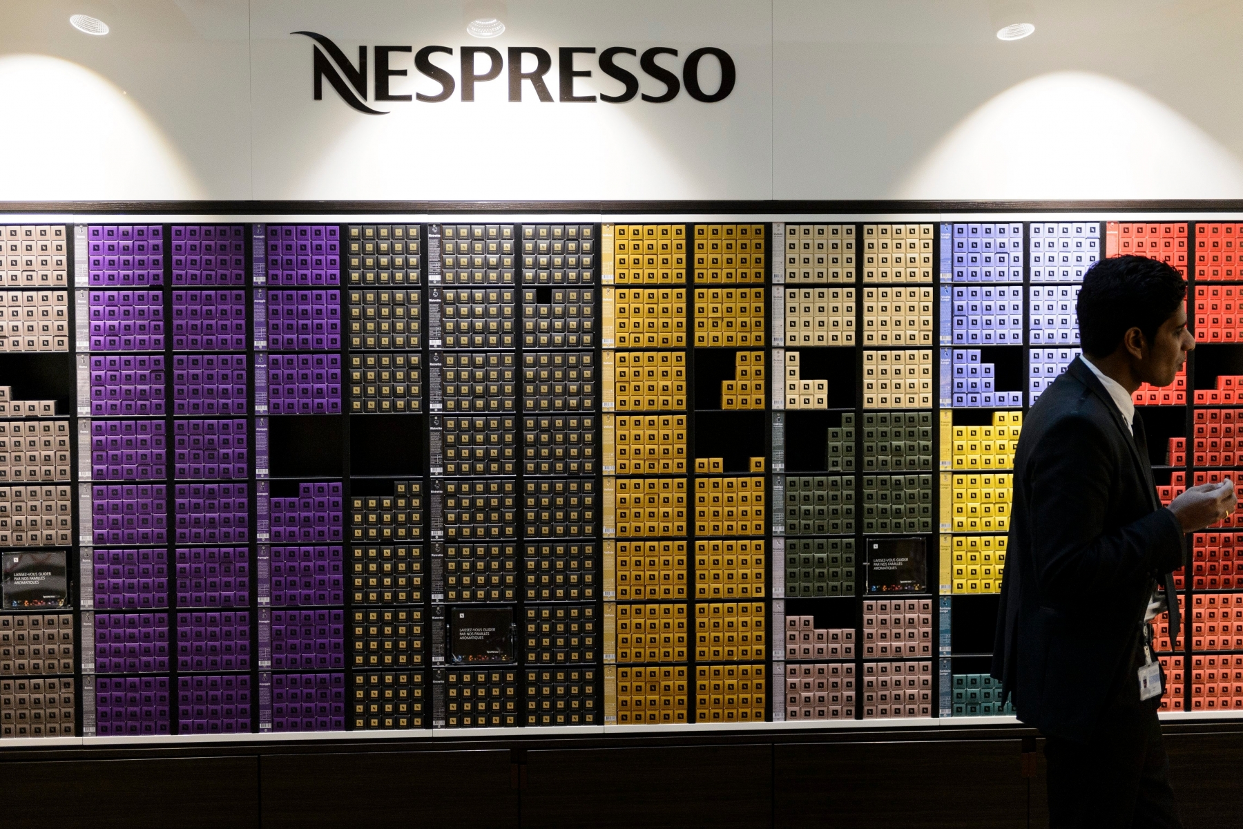 People purchases Nespresso coffee at the Nestle's own supermarket after the 2012 full-year results press conference of the food and drinks giant Nestle in Vevey, Switzerland, Thursday, February 14, 2013. Nestle SA, the world's biggest food and drinks maker, overcame tough global economic conditions to post a full-year net profit Thursday of 10.6 billion Swiss francs ($11.55 billion) for 2012, but predicted another challenging year ahead. (KEYSTONE/Laurent Gillieron) SWITZERLAND NESTLE