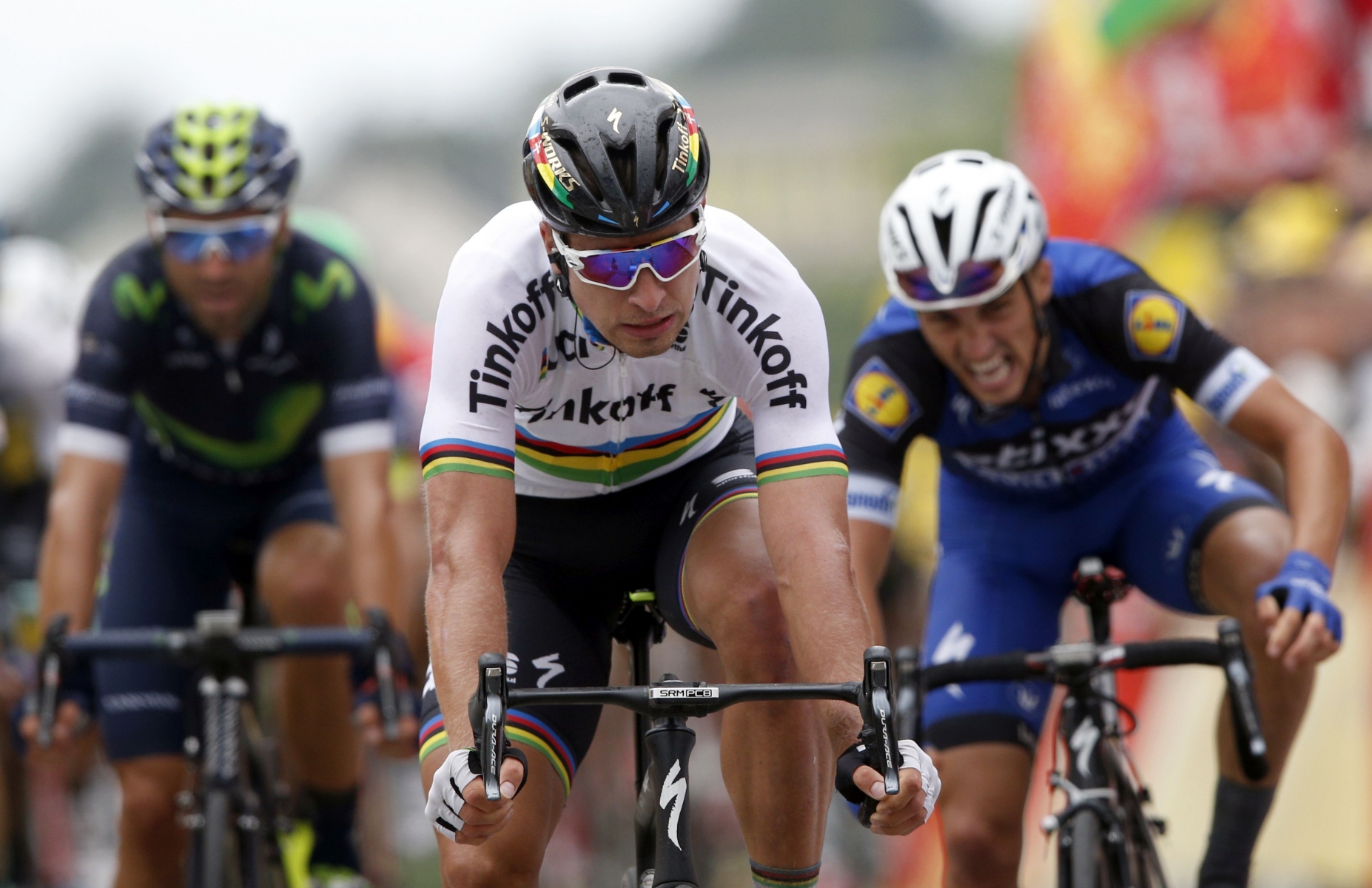 Peter Sagan of Slovakia, center, crosses the finish line to win the second stage of the Tour de France cycling race over 183 kilometers (113.7 miles) with start in Saint-Lo and finish in Cherbourg-en-Cotentin, France, Sunday, July 3, 2016. (AP Photo/Christophe Ena)