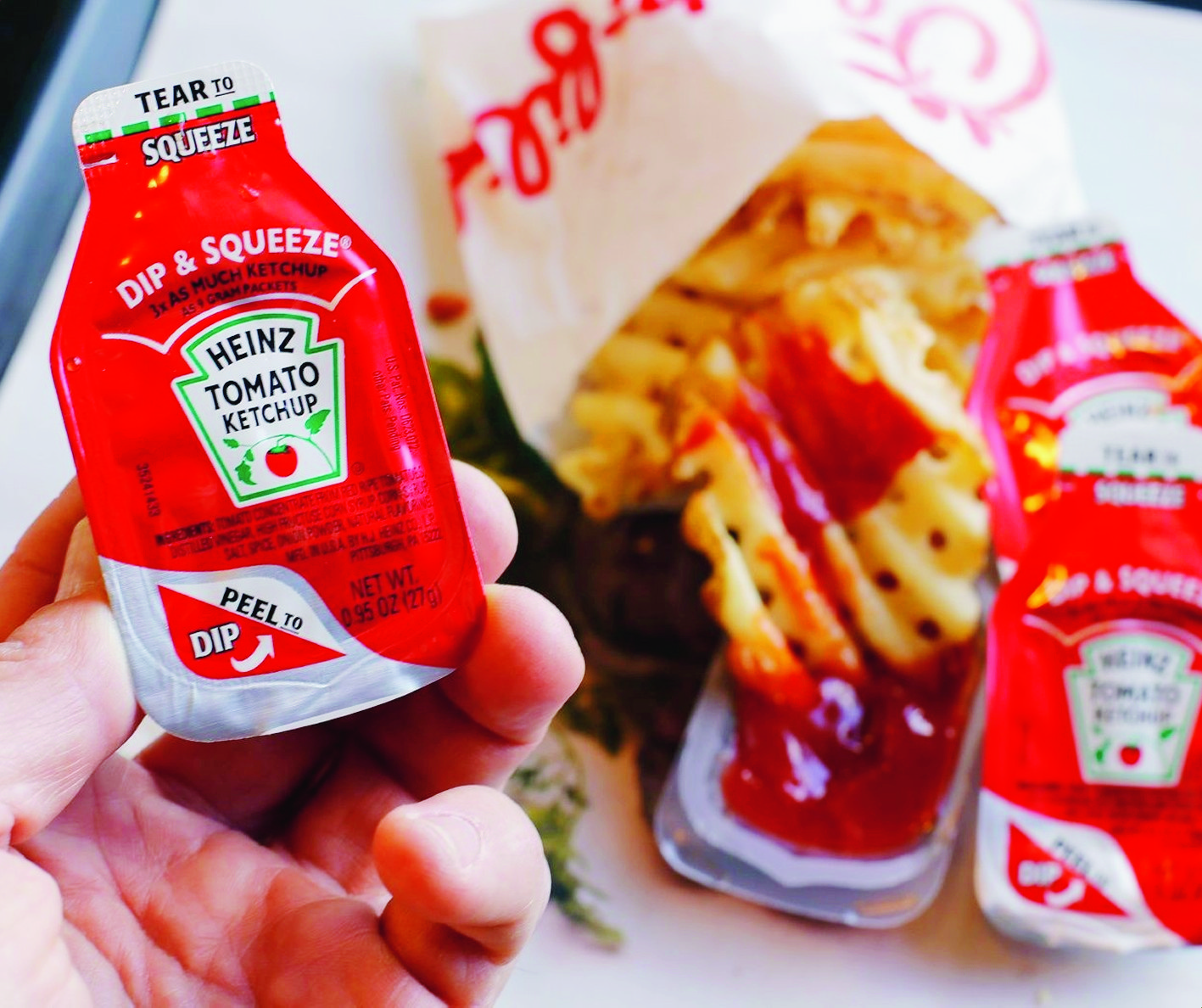 This photo shows Dip & Squeeze ketchup packets at a Robinson Township, Pa., fast food restaurant Monday, March 30, 2015. A Michigan food entrepreneur is trying to convince a federal court jury in Pittsburgh that his ìLittle Dipperî condiment package led the H.J. Heinz Co. to develop itís Dip & Squeeze ketchup packets. (AP Photo/Gene J. Puskar) Heinz Dip and Squeeze Lawsuit