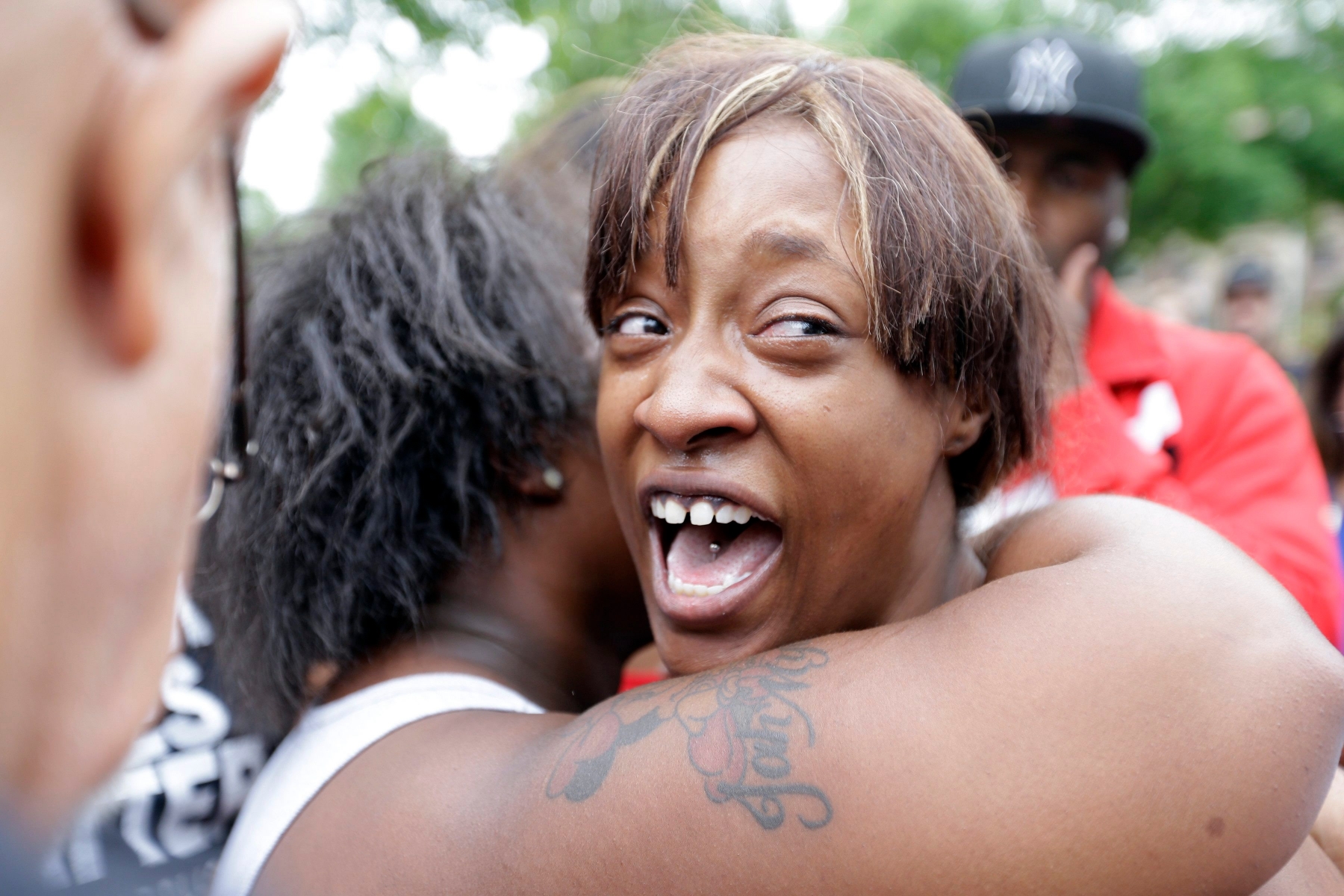 Diamond Reynolds, the girlfriend of Philando Castile,  is consoled as she talks about his shooting death with protesters and media outside the governor's residence in St. Paul, Minn. Castile was shot and killed after a traffic stop by police in Falcon Heights, Wednesday night. A video shot by Reynolds of the shooting  went viral.  (AP Photo/Jim Mone) Police Shooting Minnesota