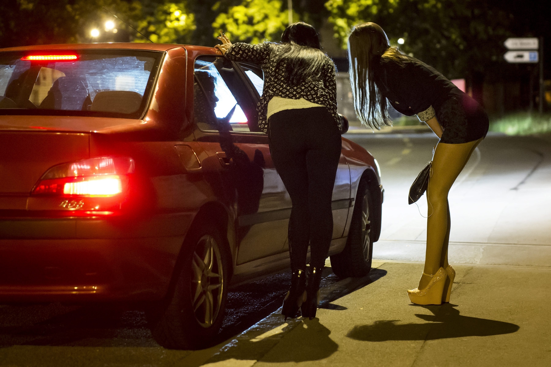 Une prostituee attend des clients qui passent en voiture sur un trottoir du centre ville dans la nuit du jeudi 7 au vendredi 8 juillet 2014 a Lausanne. La scene de la prostitution est visible sur la rue de Geneve, et l'avenue de Sevelin dans le quartier de Sebeillon a Lausanne. (KEYSTONE/Jean-Christophe Bott)
