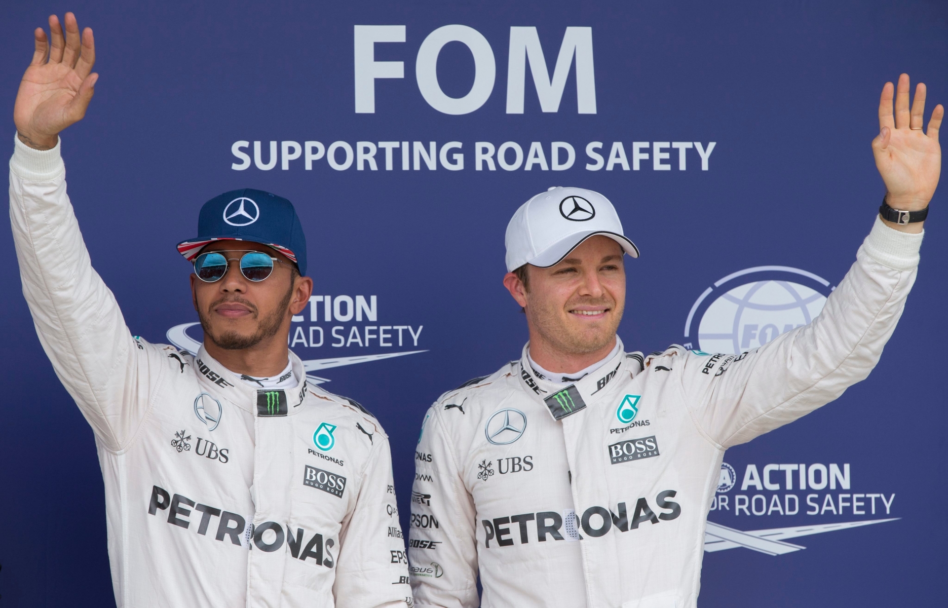 epa05416876 British Formula One driver Lewis Hamilton of Mercedes AMG GP (L) and German Formula One driver Nico Rosberg of Mercedes AMG GP (R) celebrate after the qualifying session at Silverstone race track, Britain, 09 July 2016.  Lewis Hamilton took pole position while Nico Rosberg second. The 2016 Formula One Grand Prix of Great Britain will take place on Sunday 10 July.  EPA/VALDRIN XHEMAJ BRITAIN FORMULA ONE GRAND PRIX