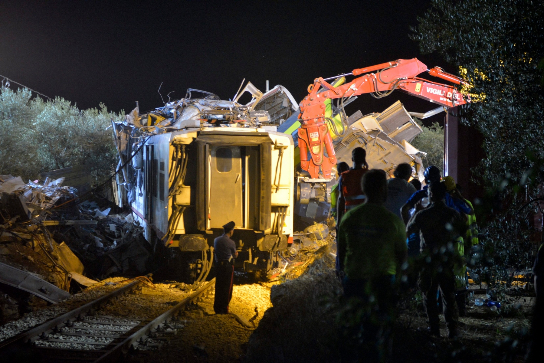 Rescuers works the scene of a train accident after two commuter trains collided head-on near the town of Andria, in the southern region of Puglia, killing several people, Tuesday, July 12, 2016.  (AP Photo/Gaetano Lo Porto) Italy Train Crash