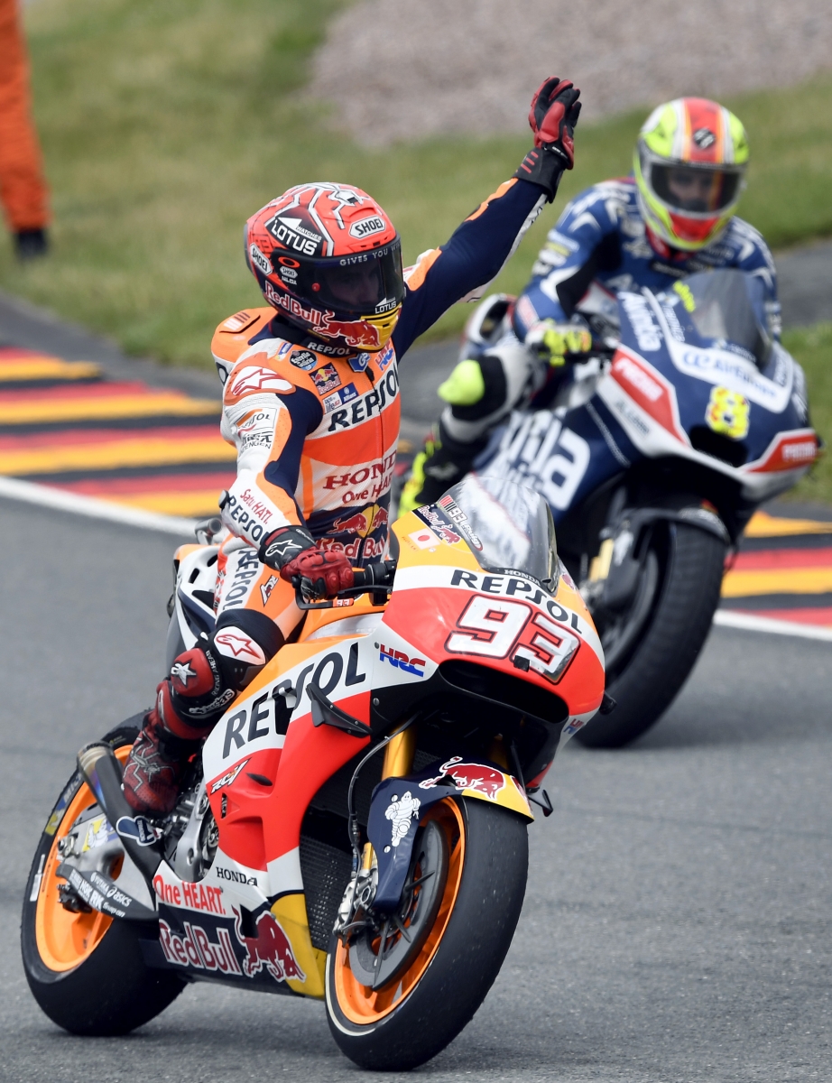 First placed MotoGP driver Marc Marquez, front, from Spain celebrates after the MotoGP race on the Sachsenring in Hohenstein-Ernstthal, Germany, Sunday, July 17, 2016. (AP Photo/Jens Meyer)