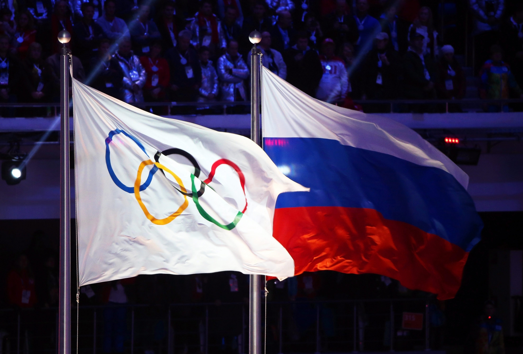 epa05439101 (FILE) A file picture dated 23 February 2014 of the Olympic flag (L) and the Russian flag (R) during the Closing Ceremony of the Sochi 2014 Olympic Games in the Fisht Olympic Stadium in Sochi, Russia. The International Olympic Committee (IOC) on 24 July 2016 announced that Russia will not receive a blanket ban from the Rio 2016 Olympic Games following the country's doping scandal. The IOC said that it would be the responsibility of the individual sports federations to check the doping records of Russian competitors under its jurisdiction.  EPA/HANNIBAL HANSCHKE *** Local Caption *** 52752743 FILE RUSSIA RIO 2016 OLYMPIC GAMES