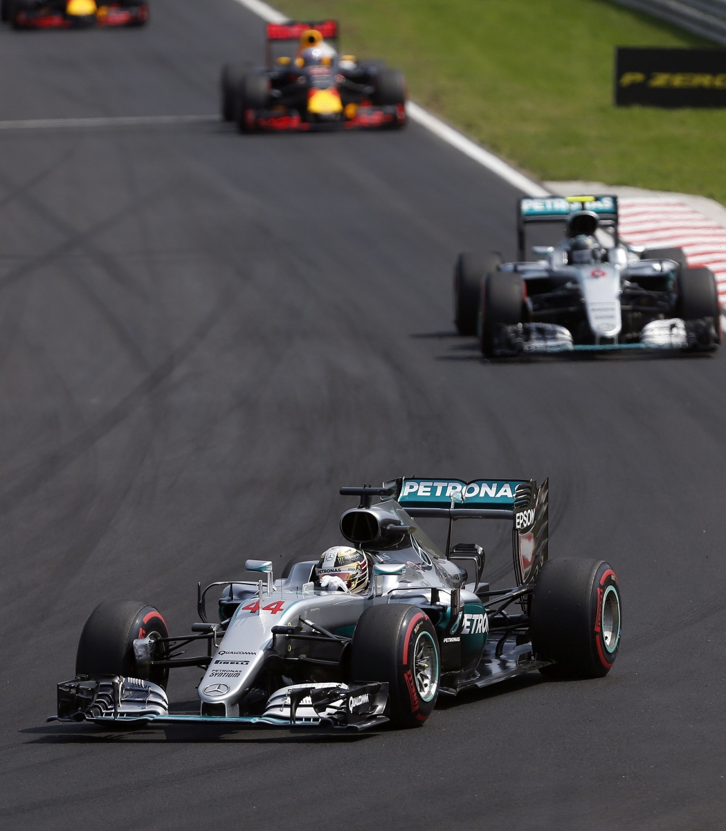 Mercedes driver Lewis Hamilton of Britain leads ahead of Mercedes driver Nico Rosberg of Germany and Red Bull driver Daniel Ricciardo of Australia, rear, during the Hungarian Formula One Grand Prix at the Hungaroring racetrack near Budapest, Hungary, Sunday, July 24, 2016.(AP Photo/Darko Vojinovic)