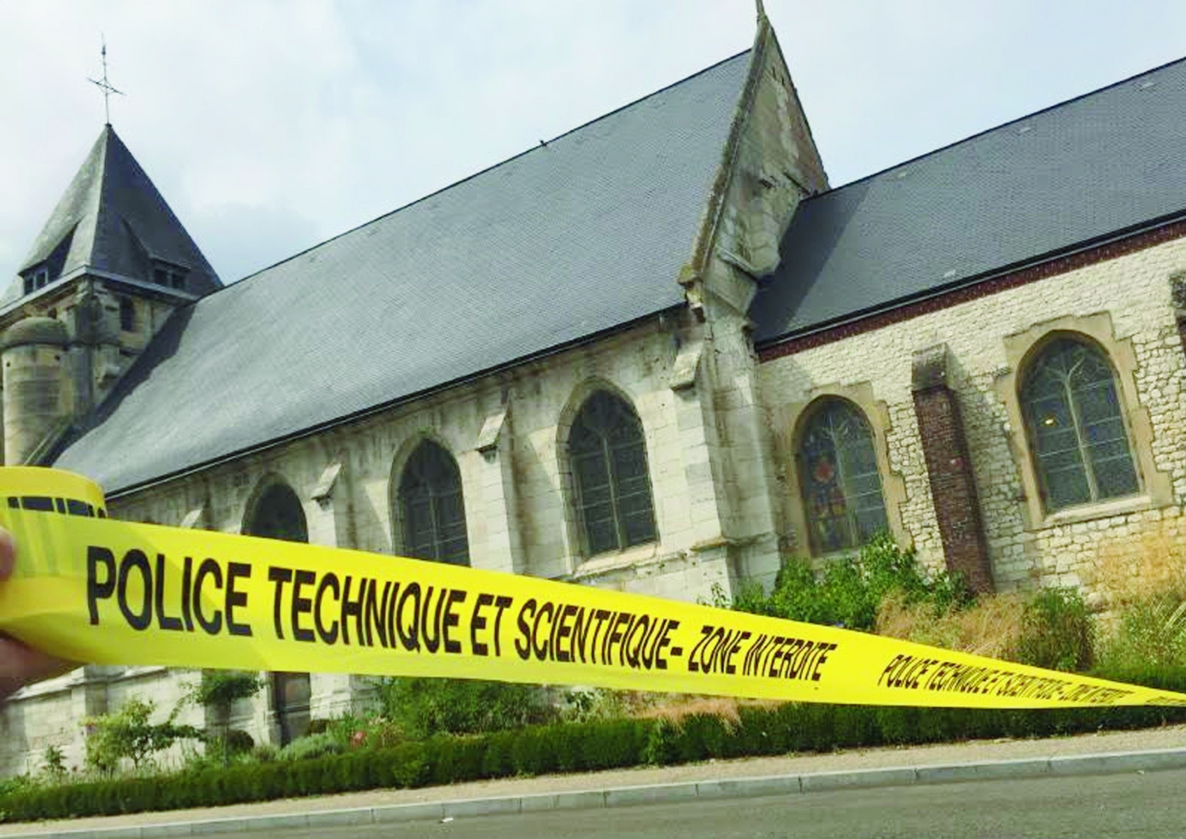 epa05442064 A handout picture provided by Police Nationale on 26 July 2016 shows police cordoning off a church where a hostage incident occured in Saint-Etienne-du-Rouvray, near Rouen, France, 26 July 2016. According to reports, two hostage takers were killed by the police after they took hostages at a church in Saint Etienne du Douvray. One of the hostages, a priest was killed by one of the perpetrators.  EPA/POLICE NATIONALE / HANDOUT BEST QUALITY AVAILABLE HANDOUT EDITORIAL USE ONLY/NO SALES FRANCE CRIME CHURCH ATTACK
