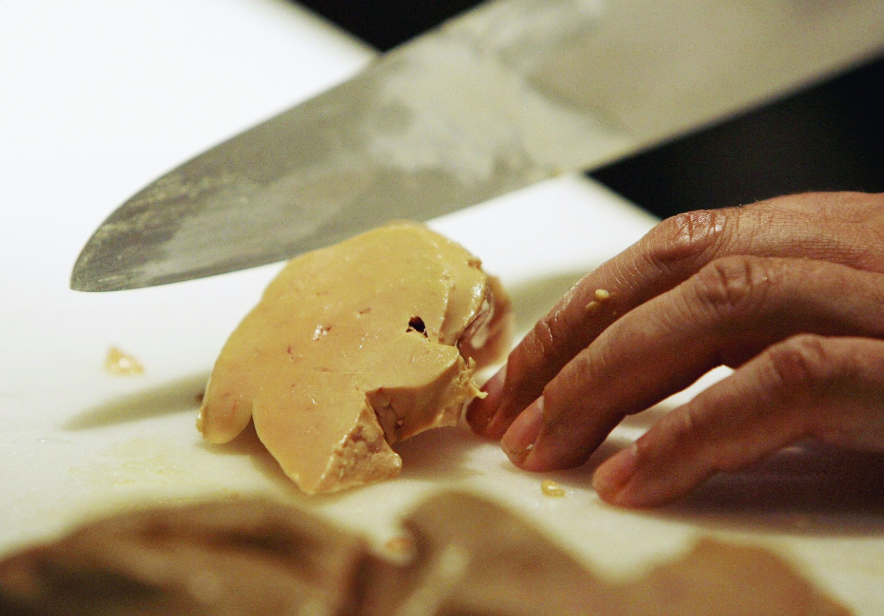 FILE - In this Aug. 9, 2006 file photo, Todd Stein, the executive chef at MK, a trendy downtown Chicago restaurant, slices a portion of foie gras. The attorney general's office filed an appeal Wednesday, Feb. 4, 2015, of a ruling that blocked the state ban on selling fatty goose or duck liver produced out of state. A federal judge ruled last month that the law doesn't trump federal poultry regulations. (AP Photo/M. Spencer Green, File) Foie Gras Ban